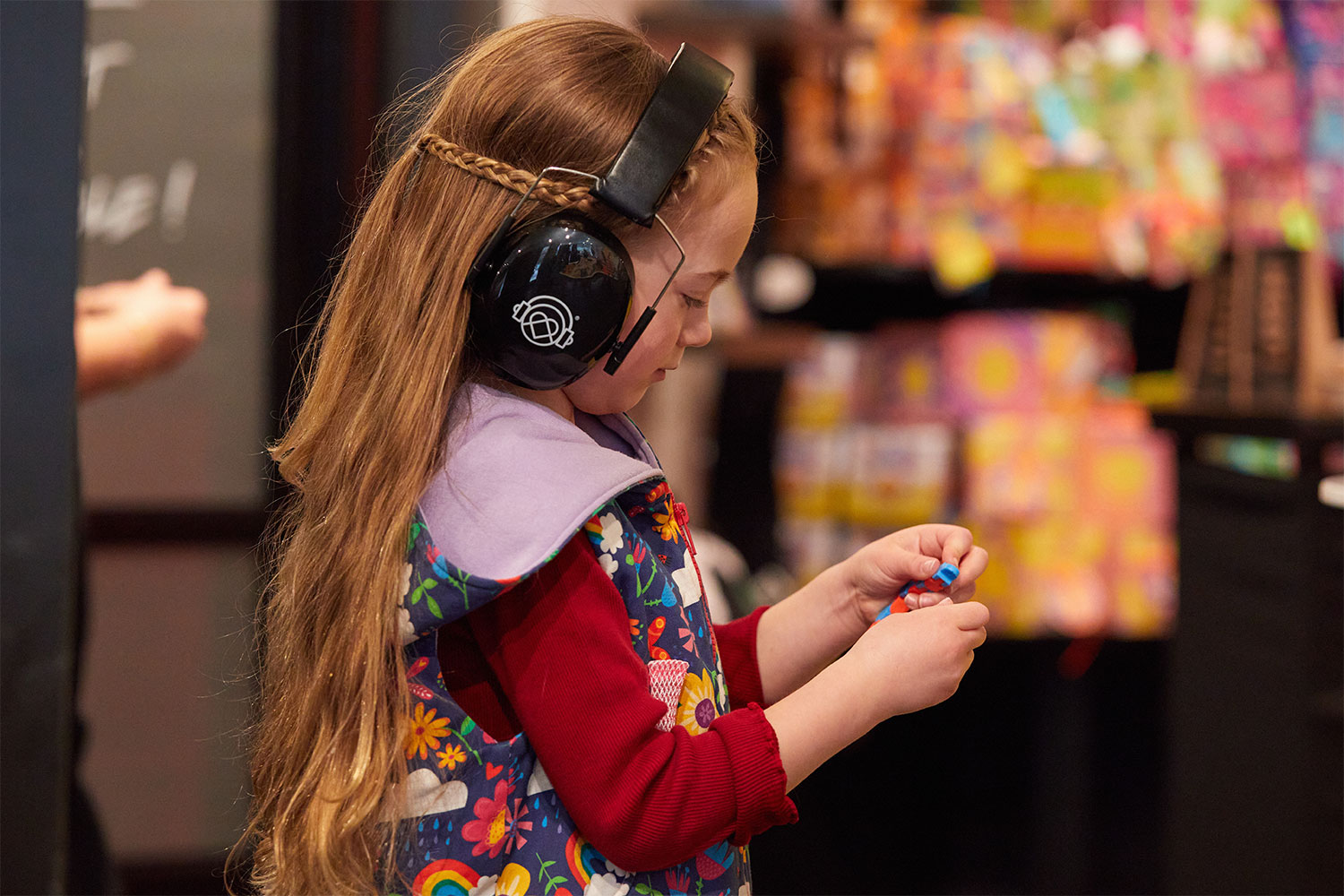 Girl wearing KultureCity headphones